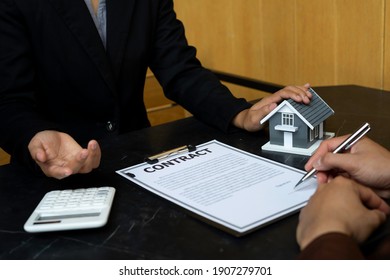 House designs with real estate agents and clients are calculating. And discussing home purchase contracts, real estate loans, lease and home purchase contracts