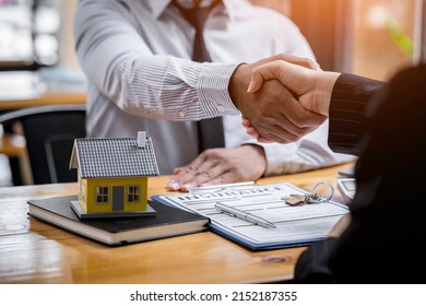 House developers and customer shaking hand after accept agreement finish buying or rental real estate for transfer right of property - Shutterstock ID 2152187355