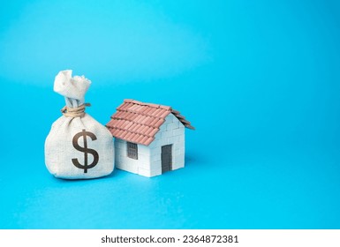 House and dollar money bag. Real estate investment. Property value appraisal. Make a deal. Property Insurance. Taxes. - Shutterstock ID 2364872381