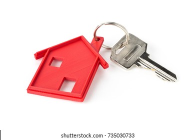 House Door Key With Red House Key Chain Pendant Over White Background