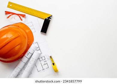 House drawing blueprints with helmet for architectural project, construction engineering. - Powered by Shutterstock