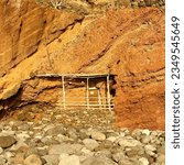 House dwelling built in the side of a rocky cliff on a beach in La  Palma,  Canary Islands, Spain. Big pebbles close up.