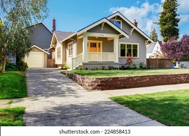 House Exterior With Front Yard Landscape. White Entrance Porch With Railings And Orange Entrance Door