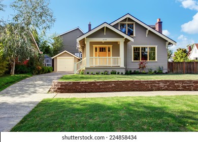 House Exterior With Front Yard Landscape. White Entrance Porch With Railings And Orange Entrance Door