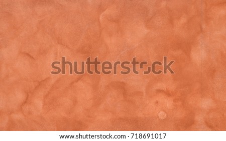 house facade in warm terracotta colors, marbled with sponge effect. Autumnal background