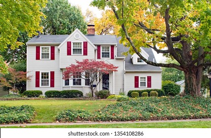 House in Fall with Red Shutters