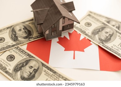 House with the flag of Canada. Immigration to Canada. Buying real estate. Houses for rent in Ottawa. Property price. Acquisition of real estate in another state. - Shutterstock ID 2345979163