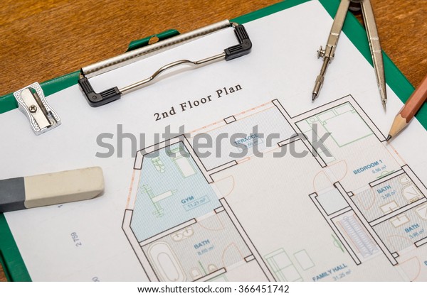 house floor\
plan with drawing compass and\
pencil
