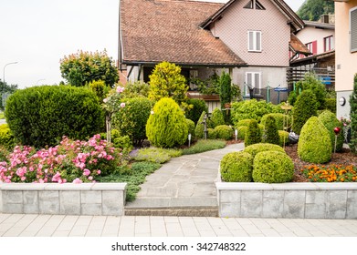 House Front Yard With Flowers And Trees In Vaduz, Lichtenstein 