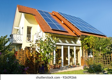 House With Garden And Solar Panels On The Roof