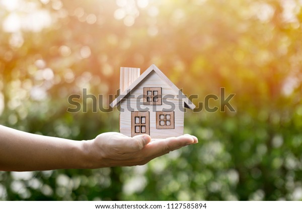 House\
in hand and sunlight show savings money and savings to buy a home\
or buy real estate. Or show a home loan or divide the investment\
for retirement. Or for the future Concept of\
money.