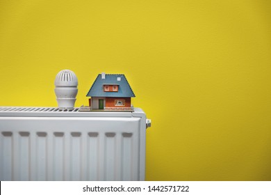 house heating system - white radiator on yellow wall copy space - Shutterstock ID 1442571722