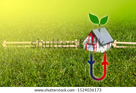 House with hermal heating system on meadow field