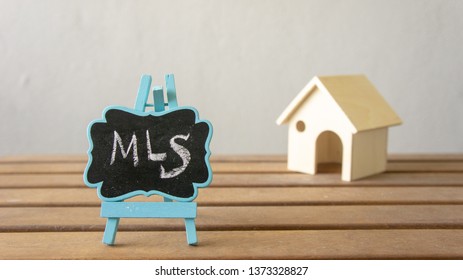 House Or Home Model With Text MLS (Multiple Listing Service) Listing (For Sale By Owner). Property Or Real Estate Concept.