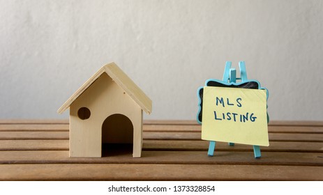 House Or Home Model With Text MLS (Multiple Listing Service) Listing (For Sale By Owner). Property Or Real Estate Concept.