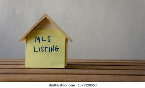 House Or Home Model With Text MLS (Multiple Listing Service) Listing (For Sale By Owner). Property Or Real Estate Concept.