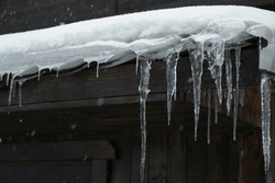 House With Icicles On Roof. Winter Season