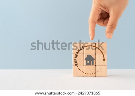 house icon inside refinance text and circle on wooden cube block , copy space included