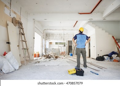 House Improvement Concept. Rear View Of Asian Construction Worker Looking Away.