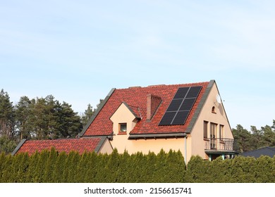 House with installed solar panels on roof. Alternative energy - Shutterstock ID 2156615741