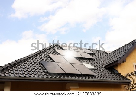 House with installed solar panels on roof. Alternative energy