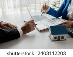 House insurance paperwork, A realtor is explaining home insurance documents to a buyer in his office at the company, Sign home insurance documents, make an agreement together.