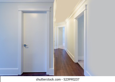 House Interior. Entrance Hallway With White Door And Hardwood Floor.