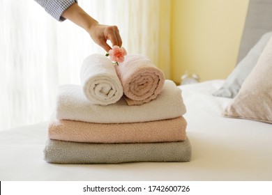 House keeping lady changing the set of folded and stacked towels in hotel room with freshly made bed, perfectly clean and ironed sheets in natural sun light. Close up, copy space for text. - Shutterstock ID 1742600726