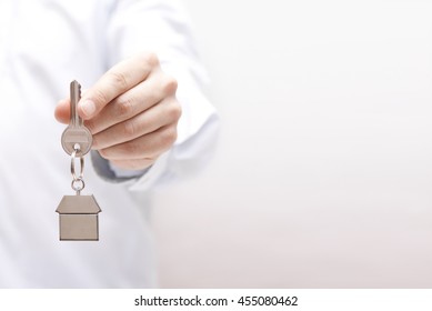 House key in hand  - Shutterstock ID 455080462