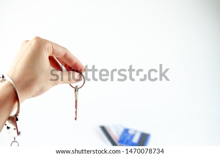 house key in hand with handcuffs isolated on white background
