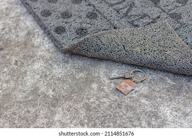 House Key Hidden Under Doormat In A Front Of House.