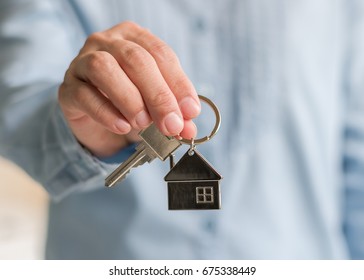 House Key Lock In Real Estate Sale Person, Landlord Or Home Insurance Broker Agent's Hand Giving To Buyer Customer For New Family Property Ownership Guarantee And Safety Assurance Concept