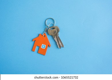 House And Key On Blue Background. Minimal Creative Style.