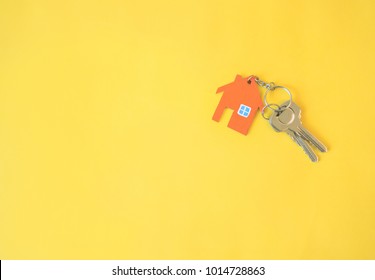 House And Key On Yellow Background. Minimal Creative Style.