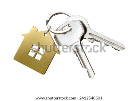 House key pair with gold metal house shaped keyring isolated on white background.