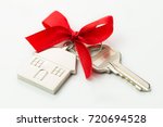 House key with red bow over white background