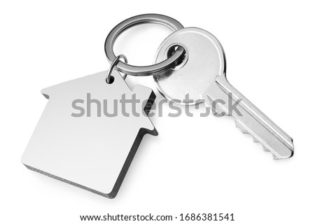House key with a house shaped keychain, isolated on white background
