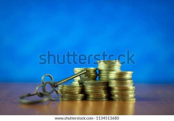 House key and\
stack coins. Key success\
concept