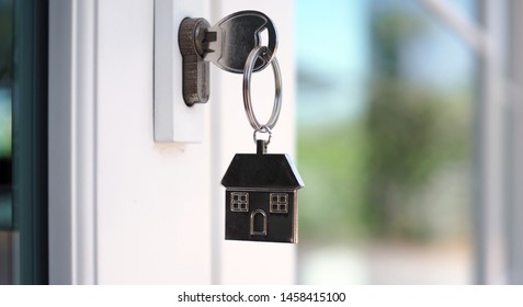 The house key for unlocking a new house is plugged into the door.        - Shutterstock ID 1458415100