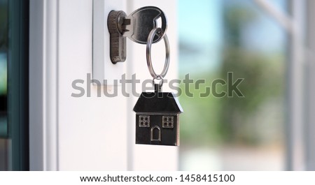 The house key for unlocking a new house is plugged into the door.       
