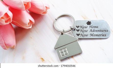 House keychain on wooden background, welcome buyer to new home. Concept of greeting customers for real estate agent. - Powered by Shutterstock