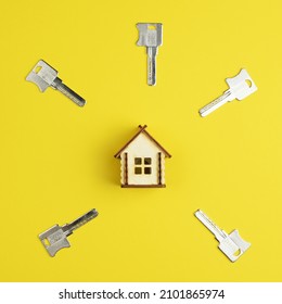 House Keys And Miniature House Model On A Colorful Bright Background. Top View, Flat Lay. Home Buying Concept.