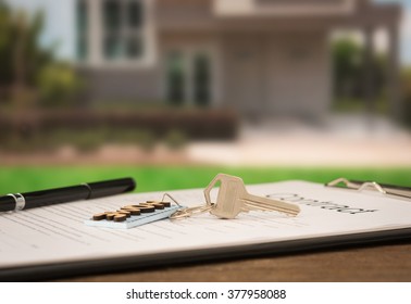 House keys on the rental agreement or the buy home contracts with the real estate property background.