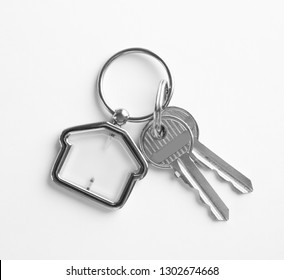 House Keys With Trinket On White Background, Top View