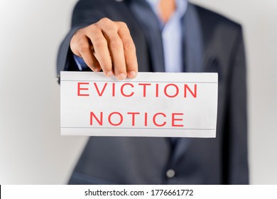 House Landlord Or Lawyer In Suit Showing Eviction Notice On Isolated Background.