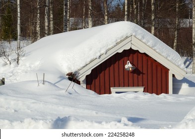 A House With Lots Of Snow On The Roof In Northern Sweden