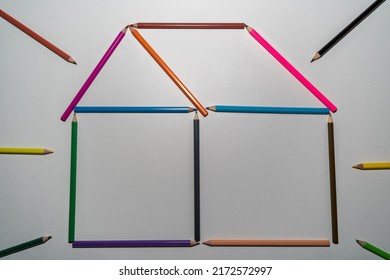 House made of colored pencils on a white background