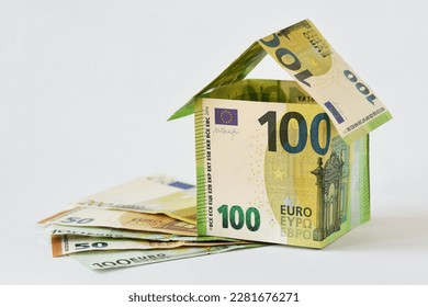 House made of euro banknotes on white background - Concept of building bonus, real estate investment, mortgage and home insurance