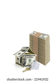 house made from hundred dollar bills and a key isolated against white background