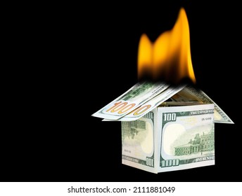 House made from one hundred dollar bills on fire. Fire insurance concept. - Powered by Shutterstock